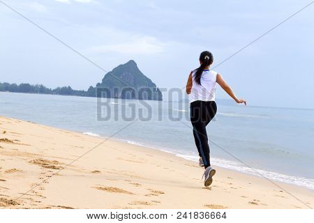 Women Good Shape Morning Running On Beach At Bang Beot Beach, Chumphon Province Thailand