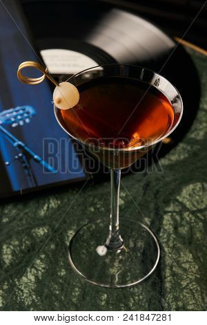 Vinyl Manhattan Cocktail On Bar Table. Freshness Alcoholic Beverage Drink With Whiskey, Rosso, Roseh