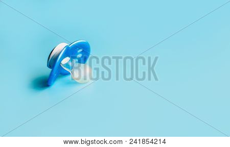 One Blue Plastic Nipple Pacifier Soother On A Blue Background, Space For Text