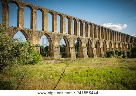 Rural landscape with ancient landmark aqueduct of Tomar region in Portugal
