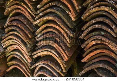 Stacks of old and dirty roof tiles