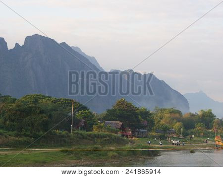 Sunset At Riverside With Mountain Background , Travel In Vang Viang City, Laos. 5Th December, 2013.
