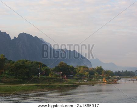 Sunset At Riverside With Mountain Background , Travel In Vang Viang City, Laos. 5Th December, 2013.