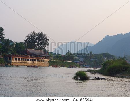 Sunset At Riverside With Mountain Background , Travel In Vang Viang City, Laos. 5Th December, 2013.