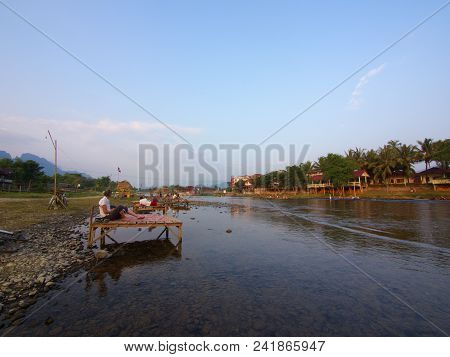 Sunset At Riverside With Mountain Background , Travel In Vang Viang City, Laos. 5Th December, 2013.