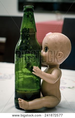 Doll Sitting Hugging Beer Bottle, Concept Image