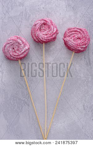 Homemade Meringues Cookies On Stick On Gray Background
