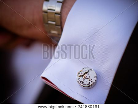 Close-up Of A Man In A Tux Fixing His Cufflink. Groom Bow Tie Cufflinks Gears