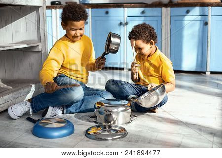 Little Musicians. Cheerful Little Boys Creating Cacophony By Drumming On Saucepans In The Kitchen An
