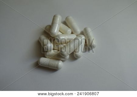 Fistful Of White Capsules Of Magnesium Citrate