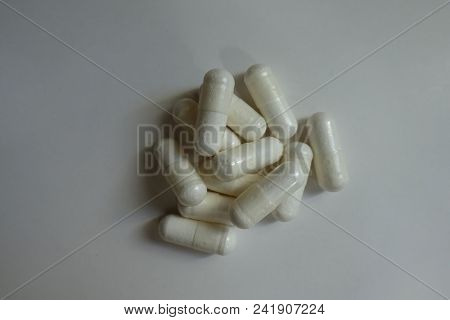 Handful Of White Capsules Of Magnesium Citrate