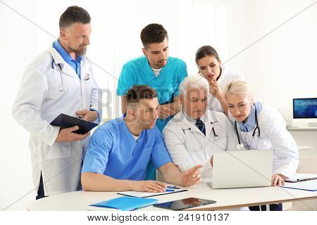 Group Of Doctors Attending Meeting In Clinic. Cardiology Conference