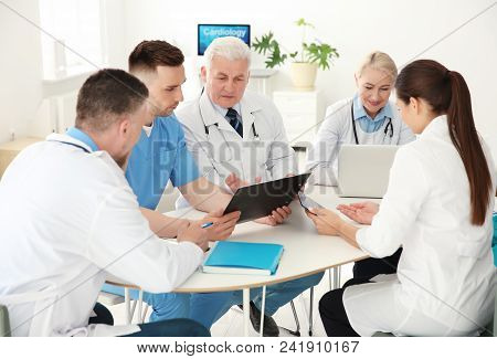 Group Of Doctors Attending Meeting In Clinic. Cardiology Conference