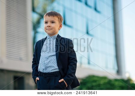 Concept Future Businessman, President, Mayor. Boy In Classic Dark Blue Business Costume And Baby Blu