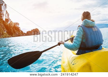Woman paddles kayak on the lake of General Carrera, Patagonia, Chile