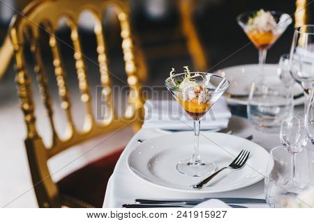 Table Setting With Beautifully Decoration, Tasty Cocktail And White Cutlery For Festive Event. Luxur