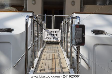 Gated Wooden Gangplank With Sign For A Private Yacht Moored In A Marina With An Electronic Control P