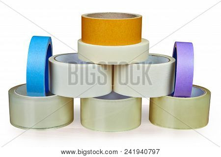 Many Rolls Of Scotch Packing Tape, And Masking Tape Is Stacked In Form Of Pyramid, Isolated On White
