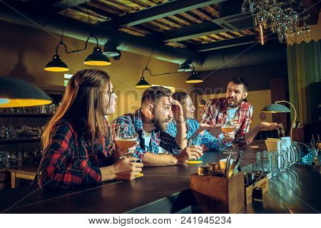 Sport, People, Leisure, Friendship, Entertainment Concept - Happy Male And Female Football Fans Or G