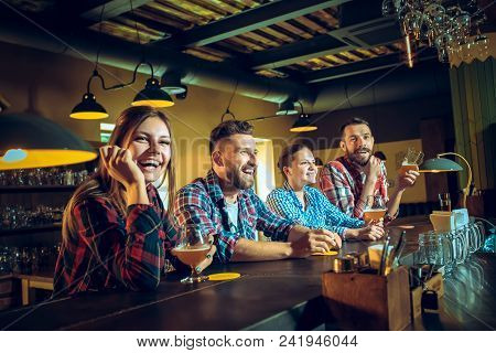 Sport, People, Leisure, Friendship, Entertainment Concept - Happy Male And Female Football Fans Or G