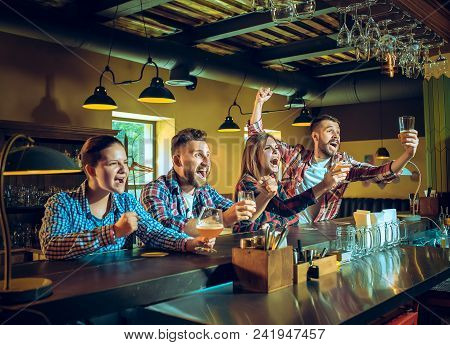 Sport, People, Leisure, Friendship, Entertainment Concept - Happy Male And Female Football Fans Or G