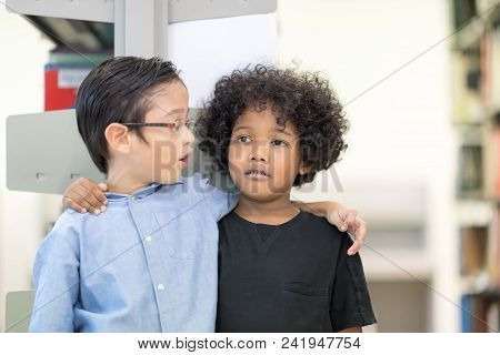 An African American Boy Stands Playing With His Friend.happy Kids Lifestlye In The Library. Young Pe