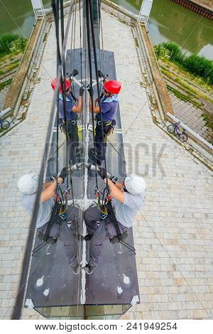 Industrial Climbers Are Applying Silicone On Joints Between Windows