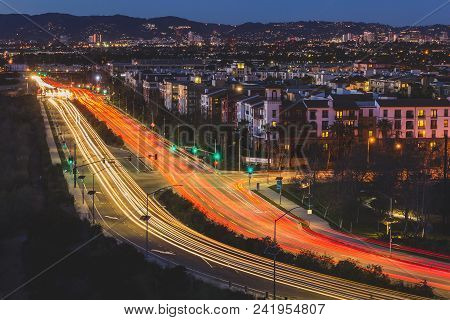 Long-exposure Light Streaks Of Traffic At Dusk Over A Busy Road In Playa Vista, California