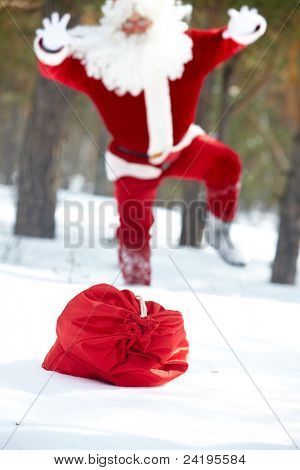 Papai Noel correndo para seu saco perdeu em madeira de Inverno