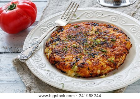 Swiss Potatoes Rosti On A White Plate.