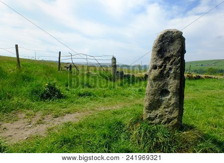 Tall Standing Stone Or Old Gatepost With Old Fending And Metal Gate In Pennine Pastureland With Summ