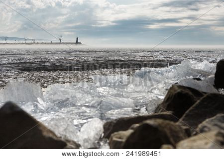 Rocky Shore. A Breakwater In The Fog On A Calm Spring River