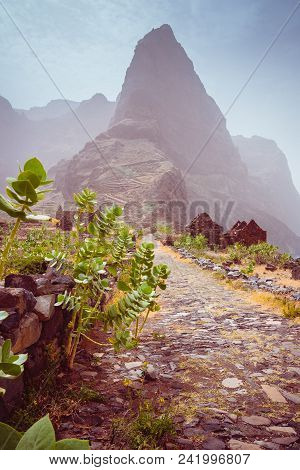 Hiking Route To Ponta Do Sol Over Amazing Aranhas Valley With Left Houses In Arid Climate. Huge Moun