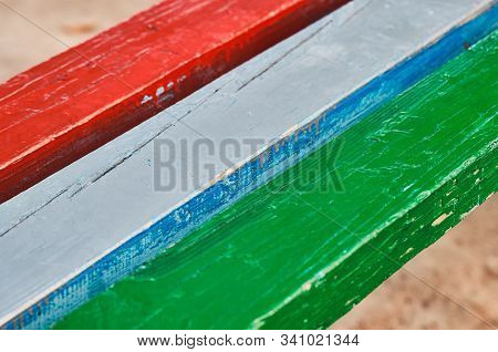 Old And Cracked Painted Wooden Planks. Red, Blue, Grey And Green Colors. Closeup Shot