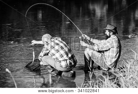 Fly Fish Hobby Of Men. Retirement Fishery. Retired Father And Mature Bearded Son. Two Male Friends F