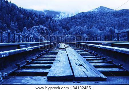 Railway Against Beautiful Mountainious Landscape. Horizon With Blue Sky, White Clouds, Mountains, Tr