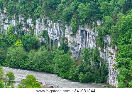 Mountain Gorge With A River Below. Canyon Of Mountain River On Steep Slopes, Misty Canyon, Flashy Ri