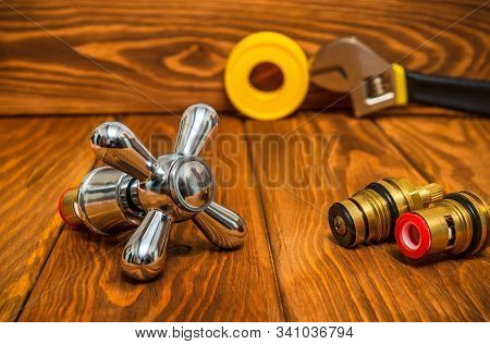 Cruciform Hot And Cold Water Main Switch Of Spare Parts On Vintage Wooden Boards