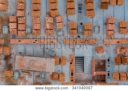 Pallets Of Clay Brick Stored For Building Construction. Construction Site Background. Top View, Ndus