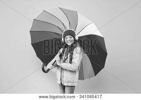 If It Should Rain. Happy Small Child In Coat Hold Colorful Umbrella Against Rain. Cute Little Girl W