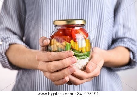 Woman Holding Glass Jar With Healthy Meal, Closeup