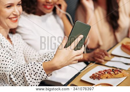 Laughing Happy Young Woman Photographing With Friends On Smartphone When Thay Are Having Lunch In Ca