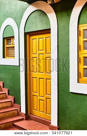 Panaji, India - December 16, 2019: Wall Of A House In Fontainhas Panjim Goa. Green Wall With A Door.