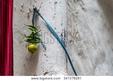 Green Chillies With A Lemon Tied On A Thread Hanging On A Doorway To Keep Away Alakshmi, Or Jyestha,