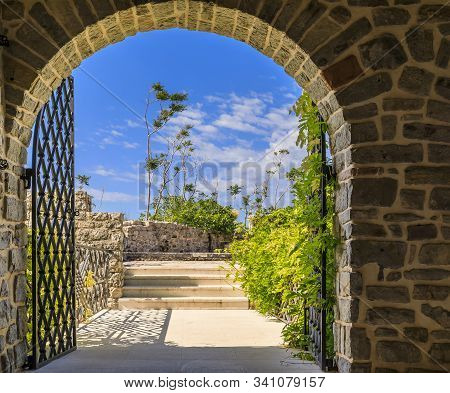 Picturesque Stone Walls And Arched Gate Of The 15th Century Citadel In The Old Town In Budva Montene