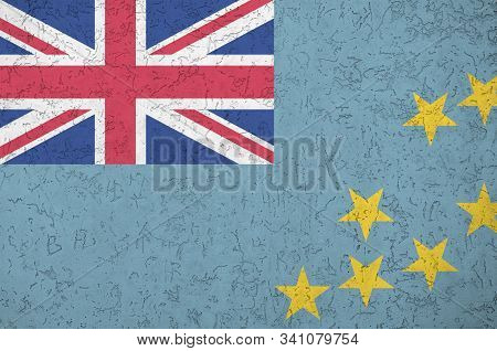 Tuvalu Flag Depicted In Bright Paint Colors On Old Relief Plastering Wall. Textured Banner On Rough 