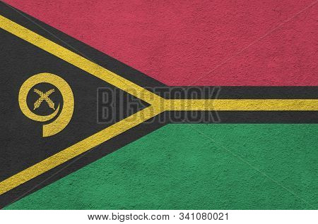 Vanuatu Flag Depicted In Bright Paint Colors On Old Relief Plastering Wall. Textured Banner On Rough