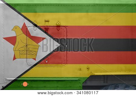 Zimbabwe Flag Depicted On Side Part Of Military Armored Truck Closeup. Army Forces Conceptual Backgr