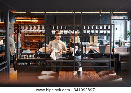 Moscow, Russia, Two Barists Are Rubbing Glasses At The Bar, A Restaurant In A Modern Style