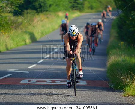 Grafham, Cambridgeshire, England - August 06, 2017:  Female Triathlete On Road Cycling Stage Of Tria